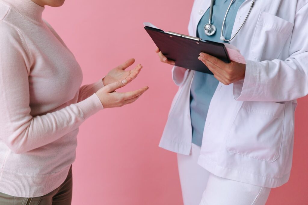 Doctor discussing paperwork with a patient during a consultation.